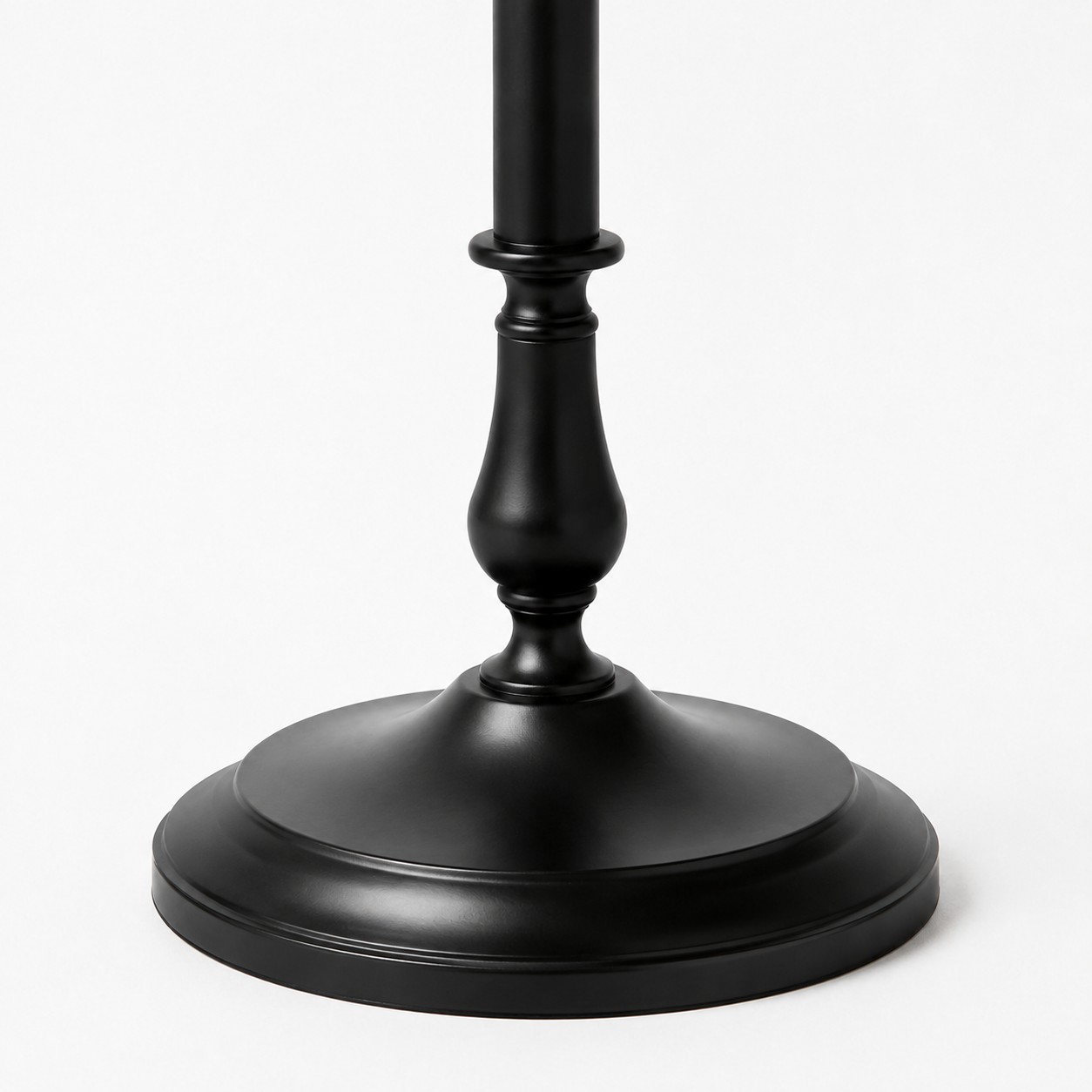 Close-up of stable round black iron floor lamp base